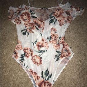 An off the shoulder body suit